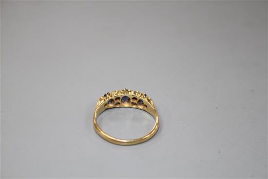 A George V 18ct gold, three stone sapphire and six stone diamond set half hoop ring,